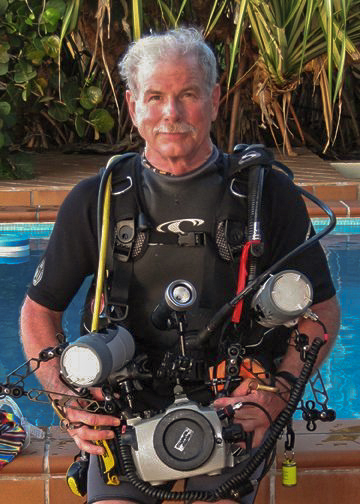 Joe Robinson with scuba gear and underwater video gear